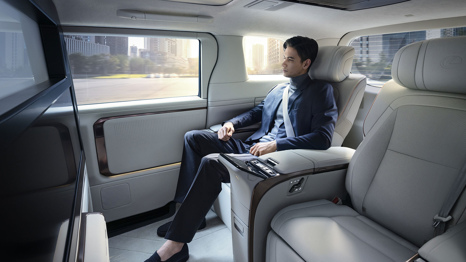 A man sits comfortably in the back passenger seat of the Lexus LM.