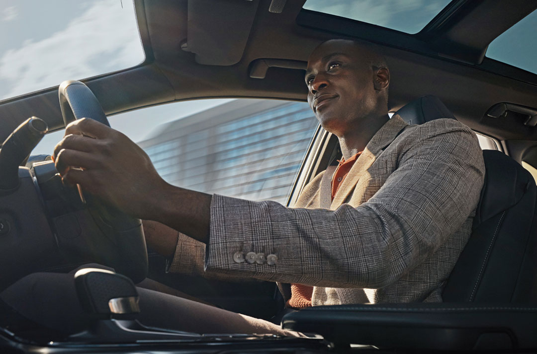 Interior view of the Lexus NX 450+ showing a man driving
